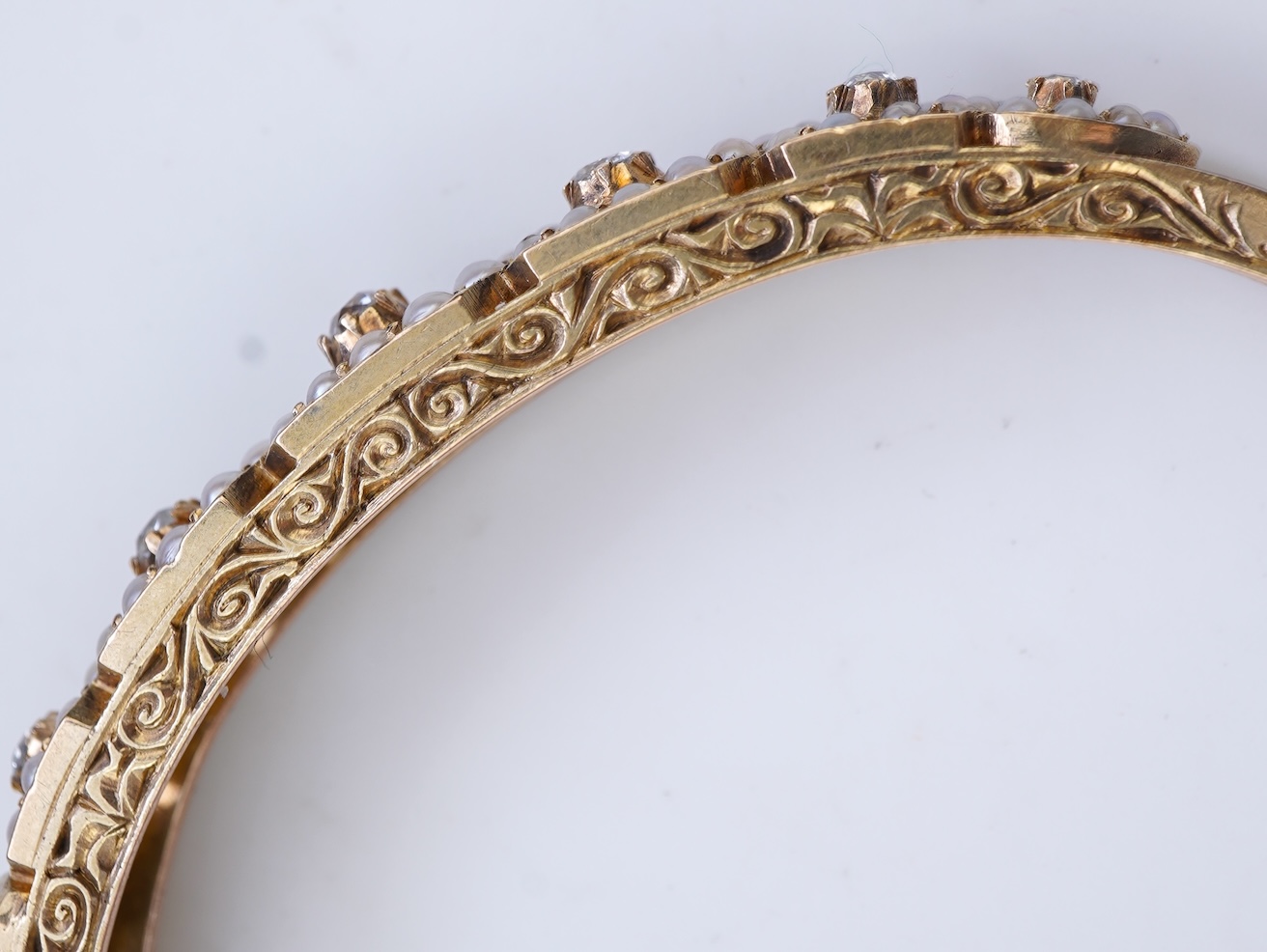 An Edwardian seed pearl and diamond bangle, early 20th century